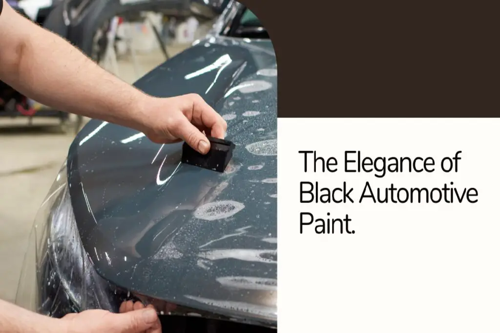 car paint black - a hand using a smooth plastic to clean a black car hood