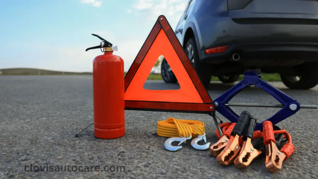 a picture of emergency kits for car consisting of a reflector, jumper cables, jack, fire extinguisher, and tow rope