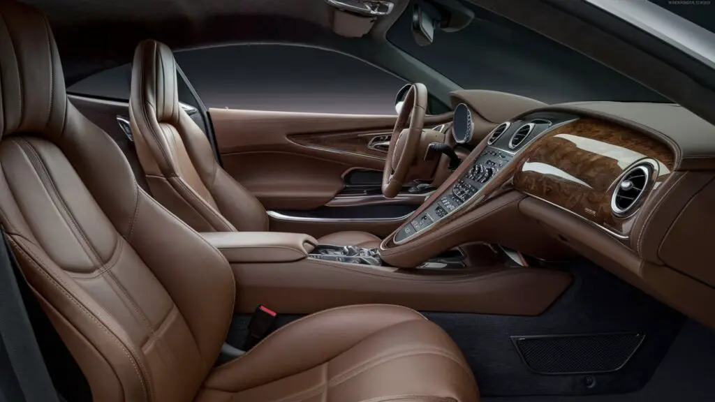 A stunningly realistic image of a luxurious car interior, showcasing the attention to detail in the craftsmanship. The seats are sumptuous leather, with intricate stitching and a warm, inviting aroma. The dashboard is a sleek blend of wood and metal, housing a collection of high-tech buttons, dials, and screens. The steering wheel is wrapped in soft leather, with a polished metal rim. The doors are adorned with elegant metal accents and house the controls for the windows and seats. The overall ambiance is one of opulence and sophistication, with a touch of futuristic flair. DIY interior detailing