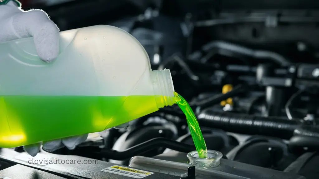 topping up coolant into a car radiator