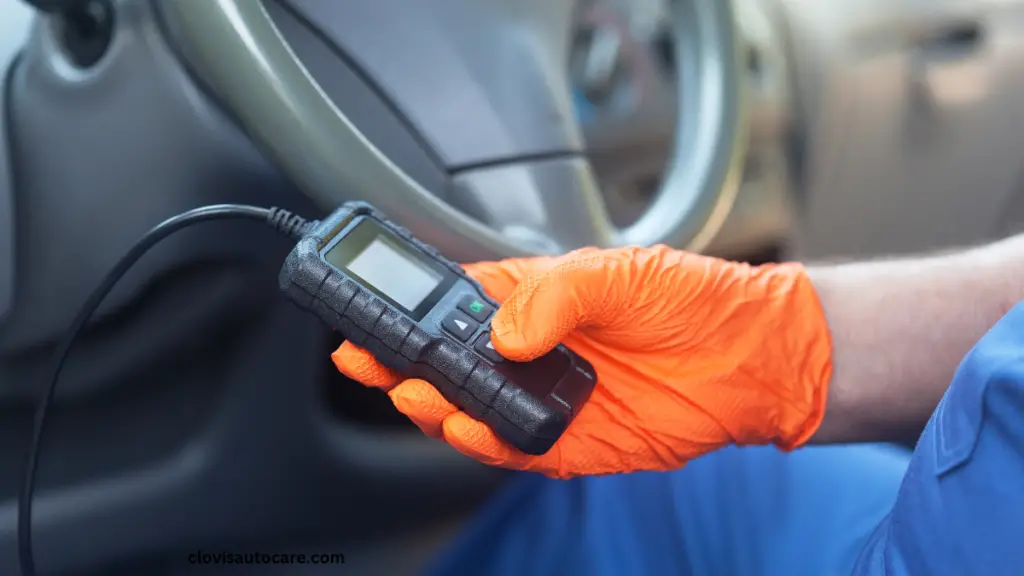 a car owner on glove using a car scanner to check car faults