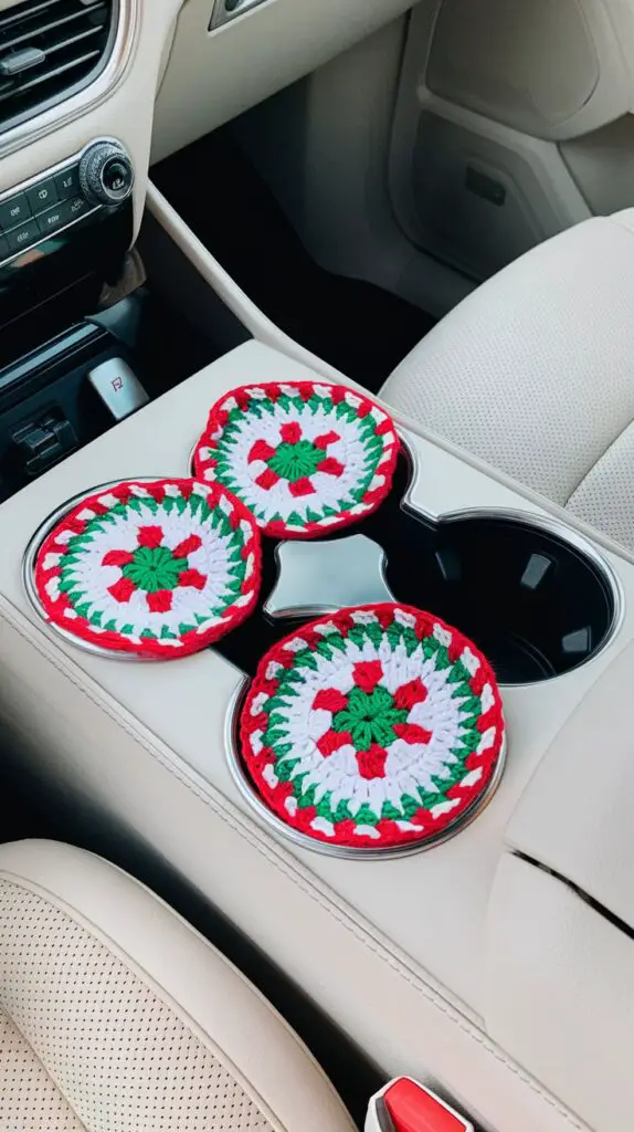 Festively designed crochet car coasters protecting cup holders in a vehicle, beautifully crafted with cheerful holiday patterns and colors