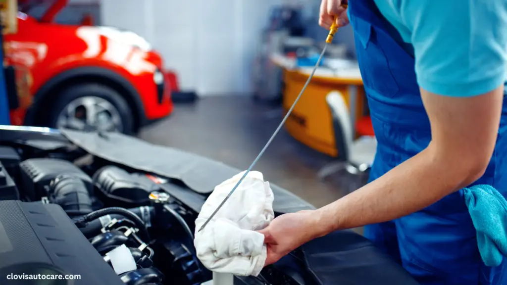 Castrol Oil Nigeria. a man using the dipstick to check engine oil level