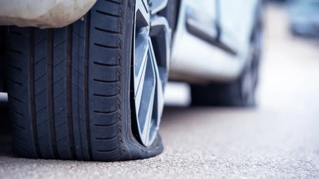 a car with a flat tire on the road.