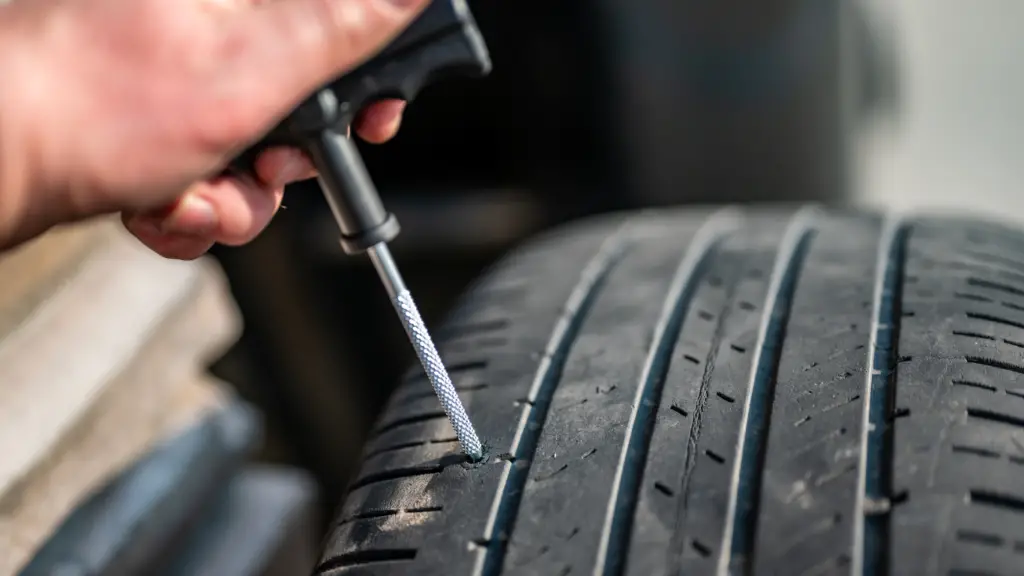 a car owner using quick fix kits to repair flat tire 