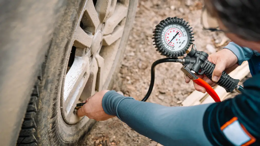 tire gauging by a car owner 